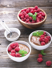 Chocolate Banana Smoothies served fresh juicy ripe raspberries with a sprig of mint in portioned bowls