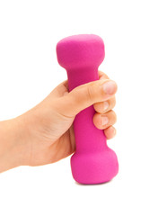 Pink dumbbells in the children's hand on an isolated background