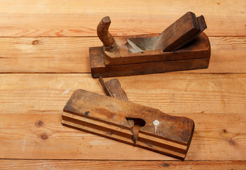 Two wooden planes on a table from boards