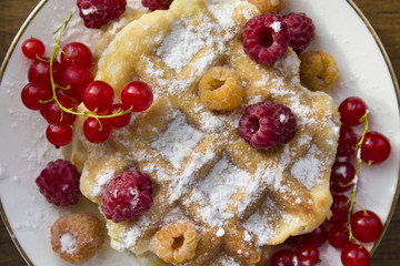 soft waffles with fresh berries, dusted with powdered sugar