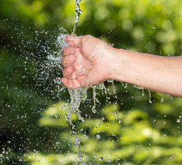 hand in the water in nature