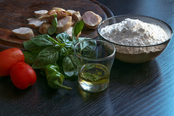 Ingredients for homemade pizza with meat, basil, tomato