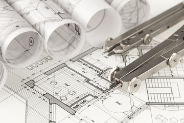 rolls of architecture blueprints, house plans &  compasses
