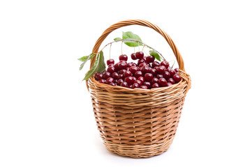Basket full of fresh red cherry on a white background