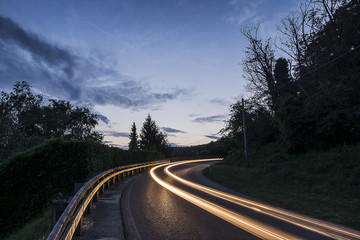 Fototapeta premium Mountain night landscape with light trails of cars
