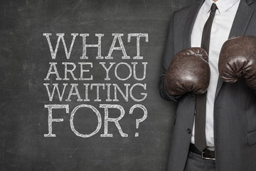 What are you waiting for on blackboard with businessman on side
