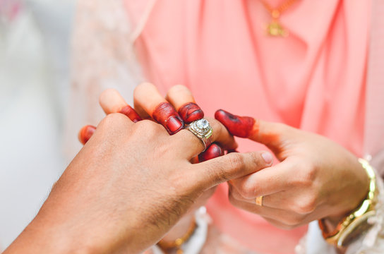 Malay Wedding Couple Putting A Ring On Hand.Selective Focus And Shallow DOF.