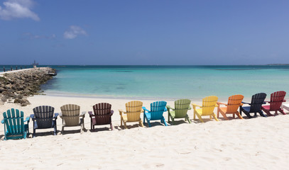 colorful beach chairs on caribbean coast