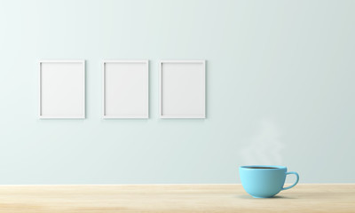 blue coffee cup on wood table and empty picture frame
