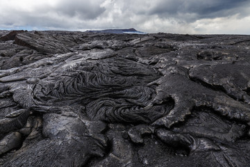Bizarre formations on the lava fields of Puu Oo, Big Island Hawaii. The shiny rock consists of very...