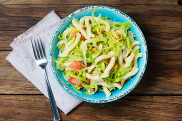 Italian food. Vegetables salad with pasta in blue bowl