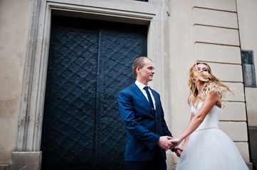 Wedding couple in the rain at old city Lviv