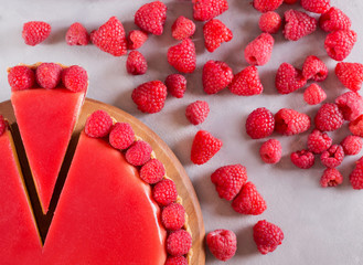 Tart, pie, cake with jellied and fresh raspberry on the light concrete background. Top view. Slice of cake