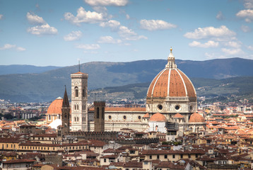 Fototapeta na wymiar Magnificent view over the historical center of Florence in Italy. The photo is taken from piazzale Michelangelo and shows the Arno river, the Duomo and many other churches and buildings 