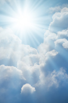 Bright sun shines among the white clouds