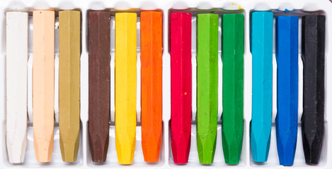 Oil Crayons with Bright Colors close up on a decorate paper shee