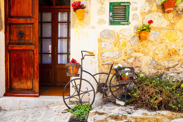 Fototapeta na wymiar Old street with decorative bike and flowers