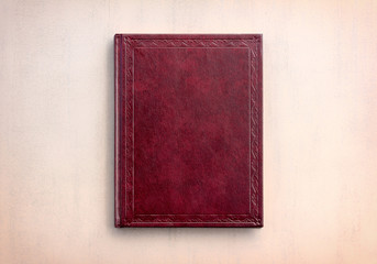 book red on a pink background, top view. tinted photo