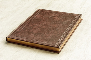 the book is brown on a gray background close up