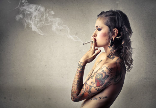 Beautiful tattooed woman smoking
