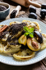 Sweet boiled dumplings filled with plum jam with a poppy seed streusel