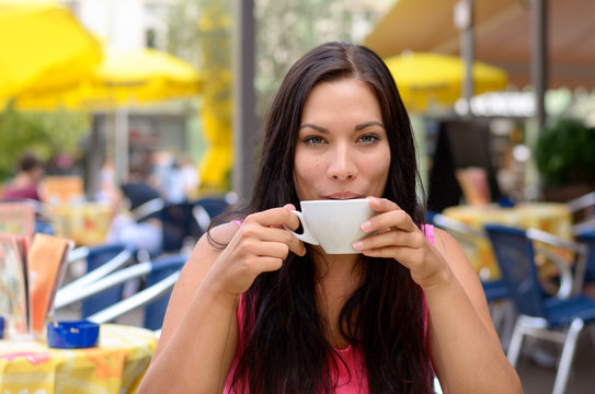 Gorgeous woman sipping coffee
