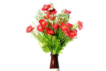 Artificial red flowers in vase on white background.