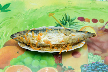 Baked mackerel in foil with vegetable oil and spices. Top view. Recipe home fish with vegetables in...