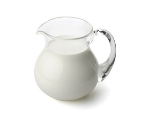 Milk in a glass jug isolated with clipping path.