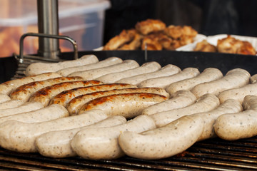 Summer. Park. Hot dogs on the grill.