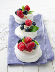 Homemade pavlova meringue cake with fresh berries and whipped cream. Morning. Dessert.