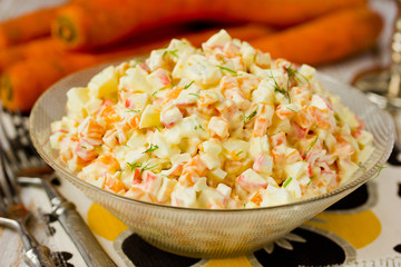 Salad with carrot and crab sticks close up