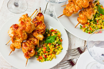 Grilled chicken satay on bamboo skewers with salsa
