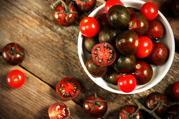 Kumato cocktail tomatoes on rustic background