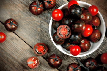 Kumato cocktail tomatoes on rustic background