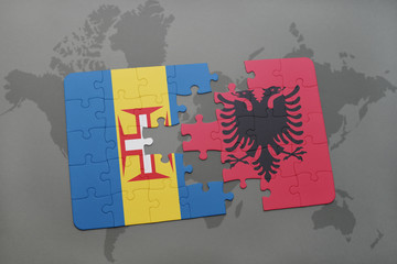puzzle with the national flag of madeira and albania on a world map background.