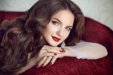 Beautiful brunette bride woman. Wedding Makeup. Red manicured na