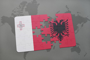 puzzle with the national flag of malta and albania on a world map background.