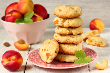 Biscuits with apricots and fresh apricots in a pink bowl