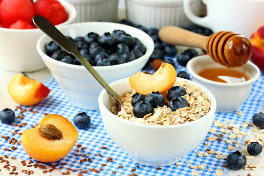 Breakfast of oatmeal with fruit, berries, honey