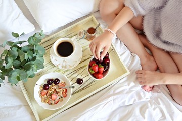 Healthy Breakfast in Bed, girl eating breakfast, top view