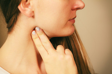 Woman checking pulse on neck closeup