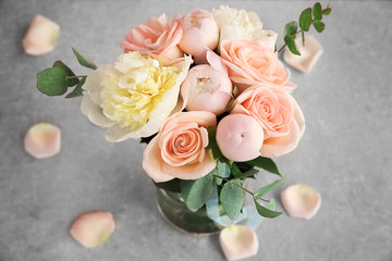 Fototapeta na wymiar Bouquet of flowers in a vase on a grey table