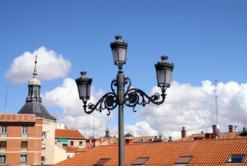 Fototapeta na wymiar Lantern on a background of city roofs