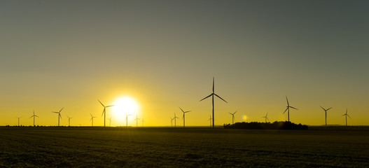 Windwheels and a beautiful sunset seen in rural France