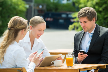 Businesspeople With Digital Tablet And Mobile Phone