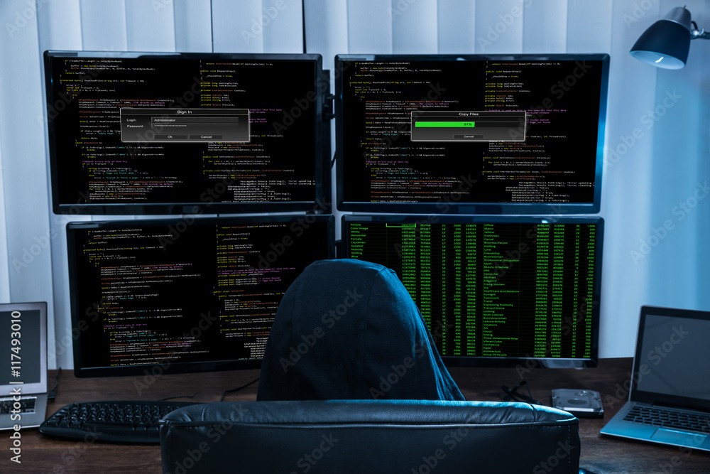 Poster Boy Sitting On Chair Hacking Multiple Computers