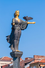 The statue of Saint Sofia in Sofia, Bulgaria rising above the city buildings.