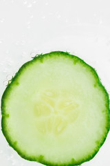 Fresh cucumber slices in sparkling water - macro image.