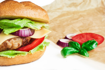 Big burger with vegetables, beef meatball and cheddar cheese.